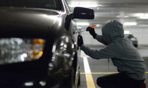 A thief trying to thief a car